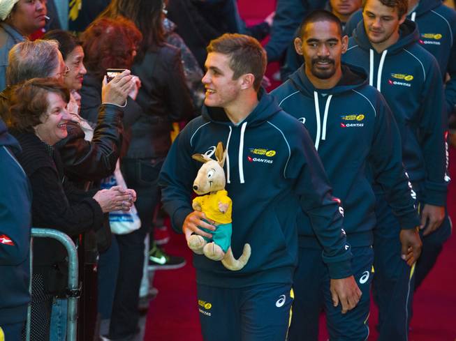 USA Sevens International Rugby Tournament players from Australia, one carrying a stuffed kangaroo, greet fans along the red carpet during a parade to the opening ceremonies at the Fremont Street Experience on Thursday, Jan. 23, 2014.